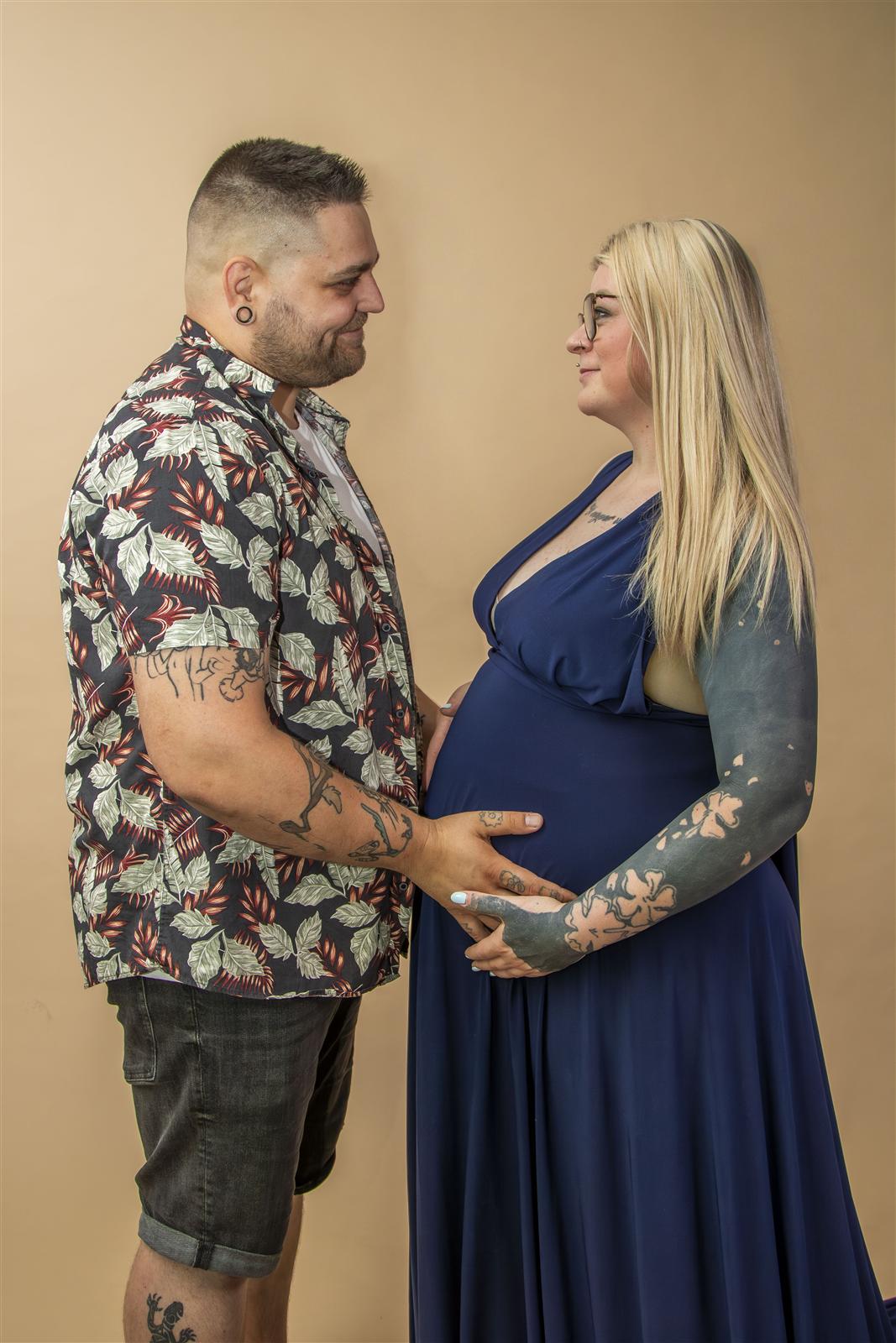 Kismama és párja profilból, homlokukat összeérintve